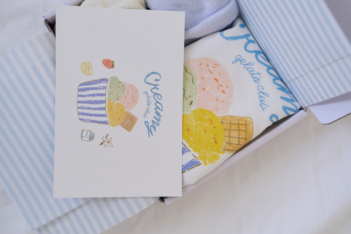 Creamy printed gelato card and striped tissue paper in gift box
