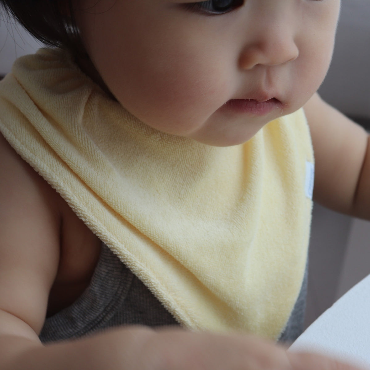 Baby wearing Creamy Gelato Bib in Lemon
