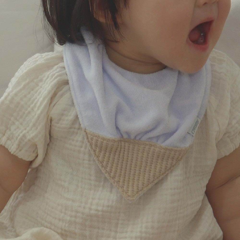 Baby wearing Creamy Blueberry Cone Bib