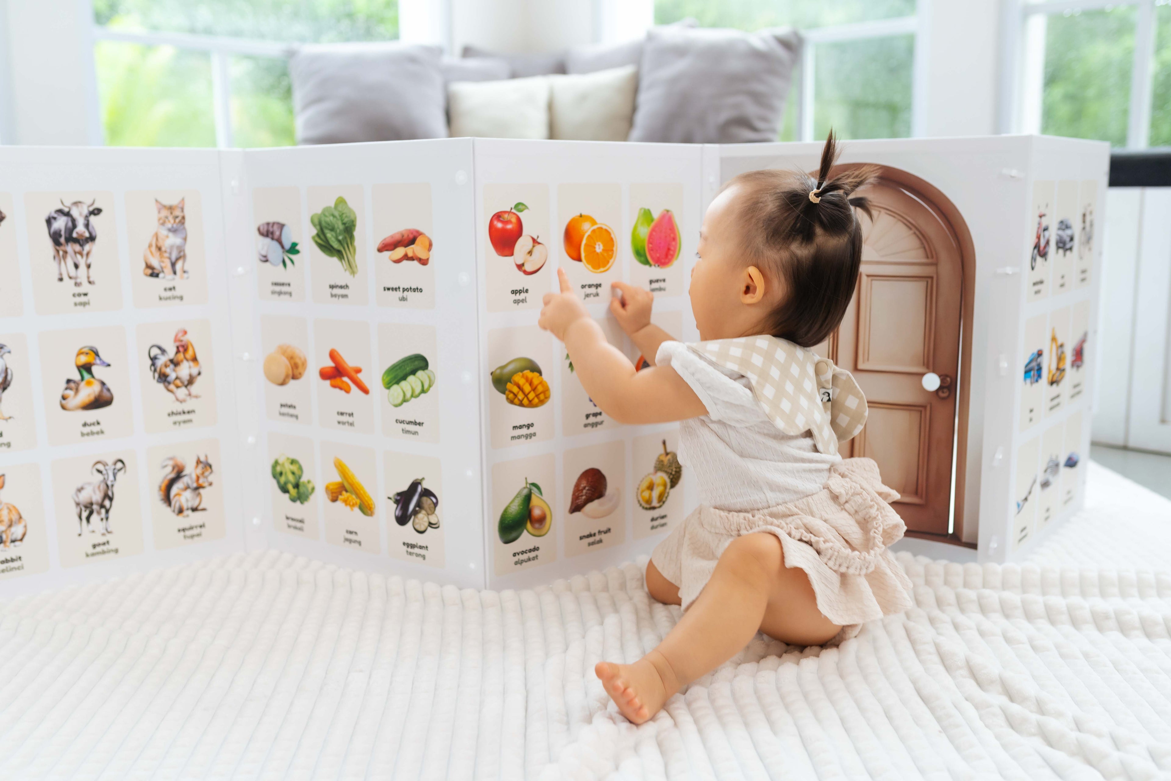 Baby interacting with premium baby learning panel